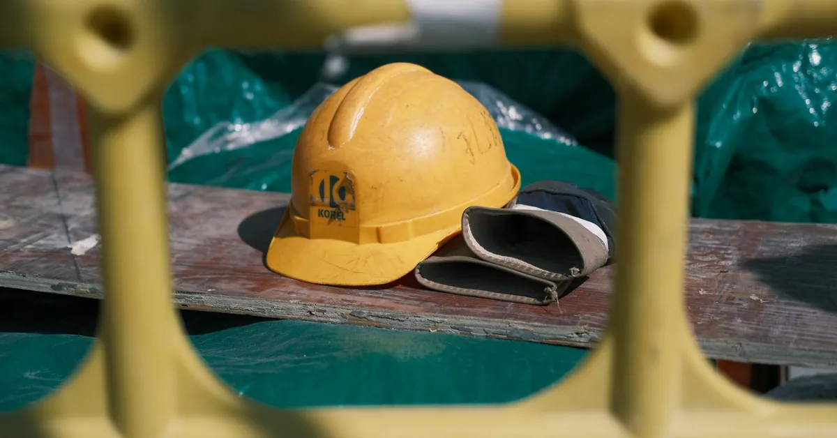 Close-up of a yellow construction helmet on a workbench at a building site. yellow construction helmet on industrial site