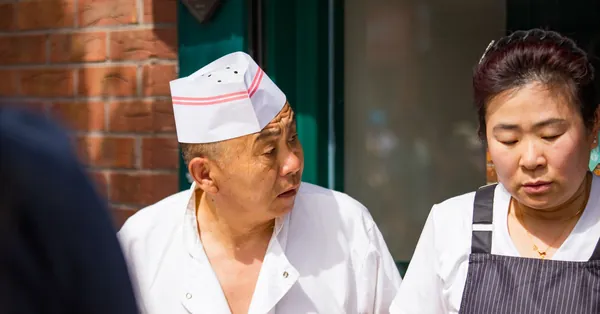 Two chefs engage in conversation outside a Dublin restaurant, capturing culinary culture. chefs in discussion outside dublin restaurant