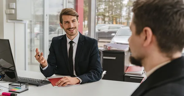 Two businessmen having a conversation in a modern office setting. businessman talking with client
