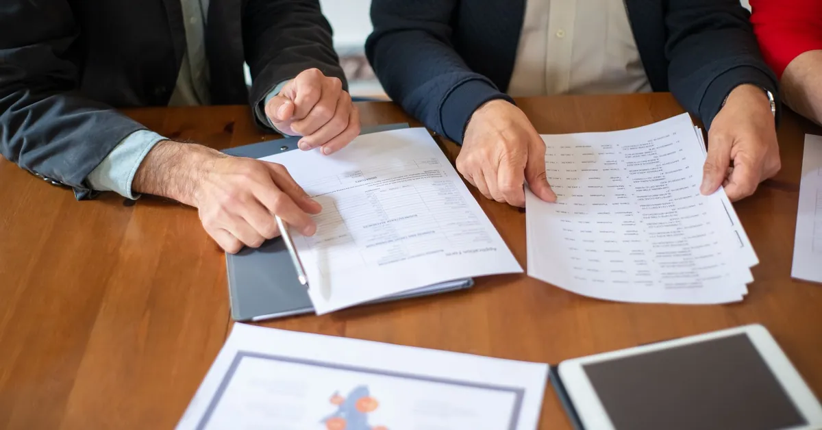 Two business professionals discussing and reviewing documents during a meeting. office workers looking at documents during a business meeting