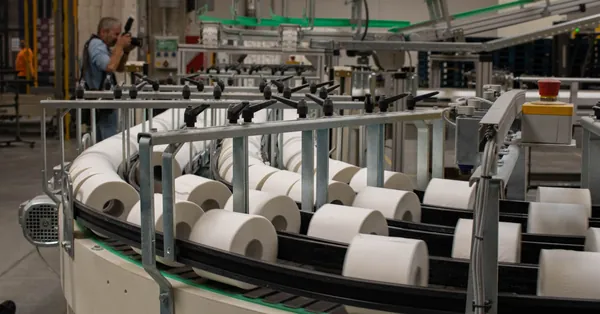 Photographer captures a production line for toilet paper in an industrial setting. production line of toilet paper