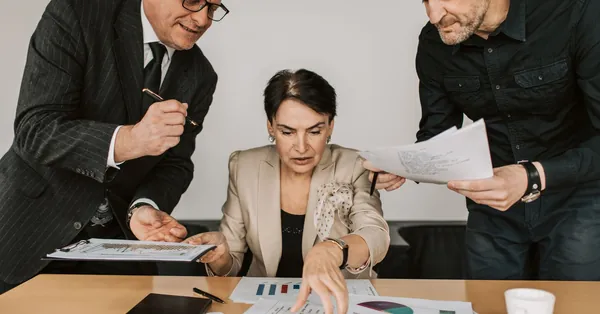 Business team collaborates on financial strategies during an office meeting. Engaged discussion over reports. business partners having a meeting at the office